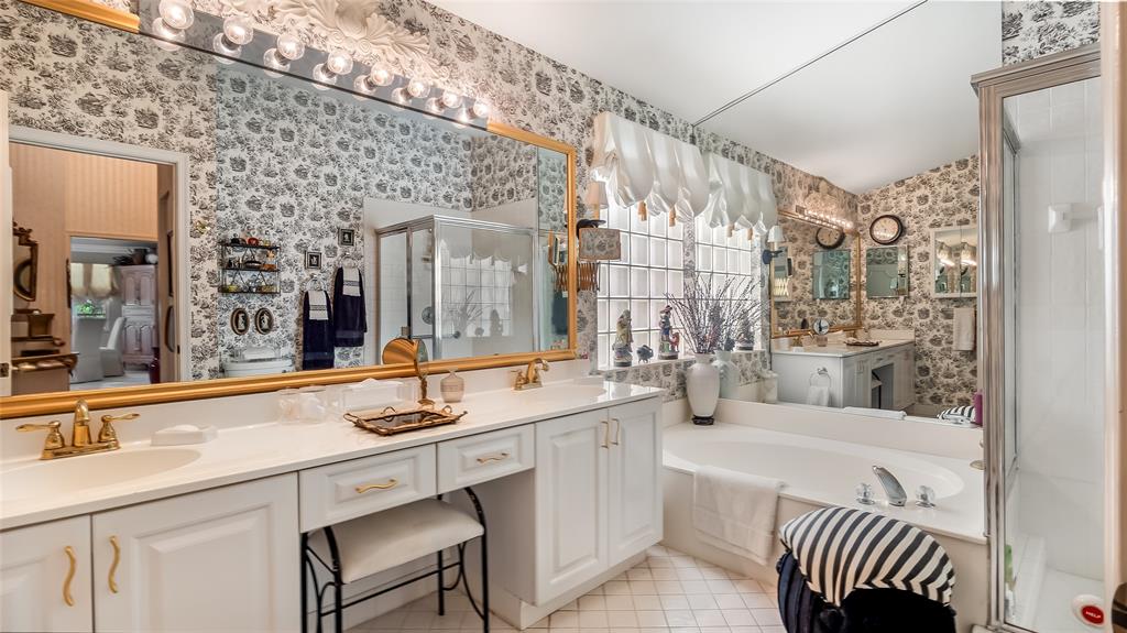 7844 Travelers Tree Drive Boca Raton, FL 33433 - Photo 19 of 40 a bathroom with a sink a mirror a bathtub and next to a window