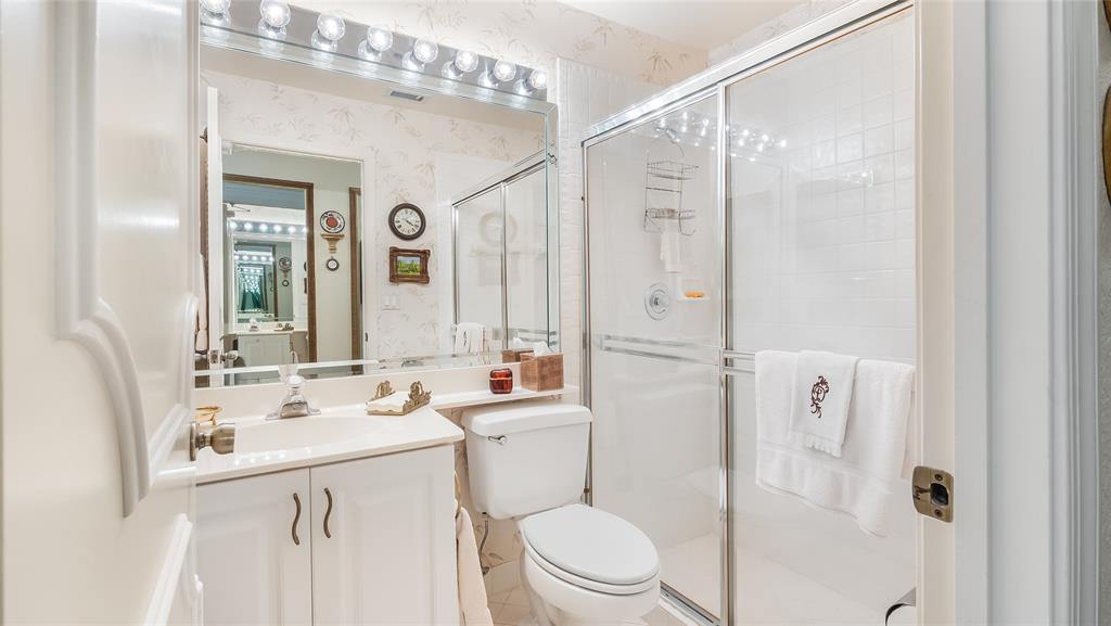7844 Travelers Tree Drive Boca Raton, FL 33433 - Photo 22 of 40 a bathroom with a sink a toilet a mirror and shower