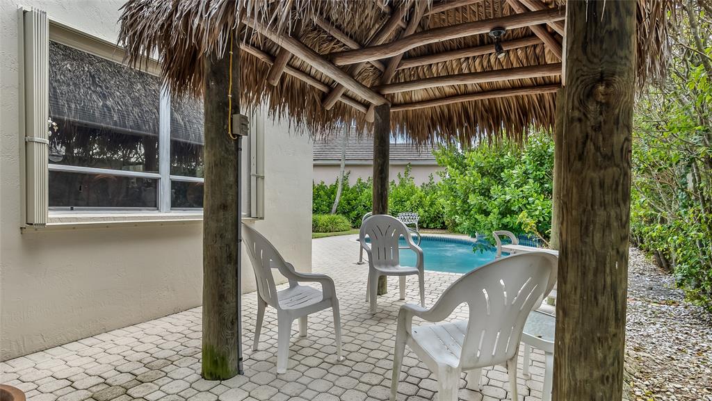 7844 Travelers Tree Drive Boca Raton, FL 33433 - Photo 33 of 40 a view of a patio with table and chairs and potted plants