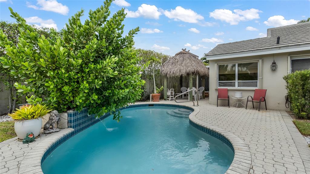 7844 Travelers Tree Drive Boca Raton, FL 33433 - Photo 35 of 40 a view of a patio with couches table and chairs and potted plants