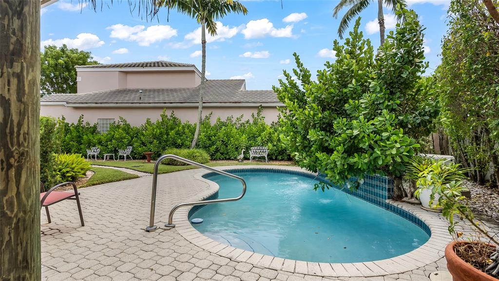 7844 Travelers Tree Drive Boca Raton, FL 33433 - Photo 36 of 40 a view of swimming pool with a yard