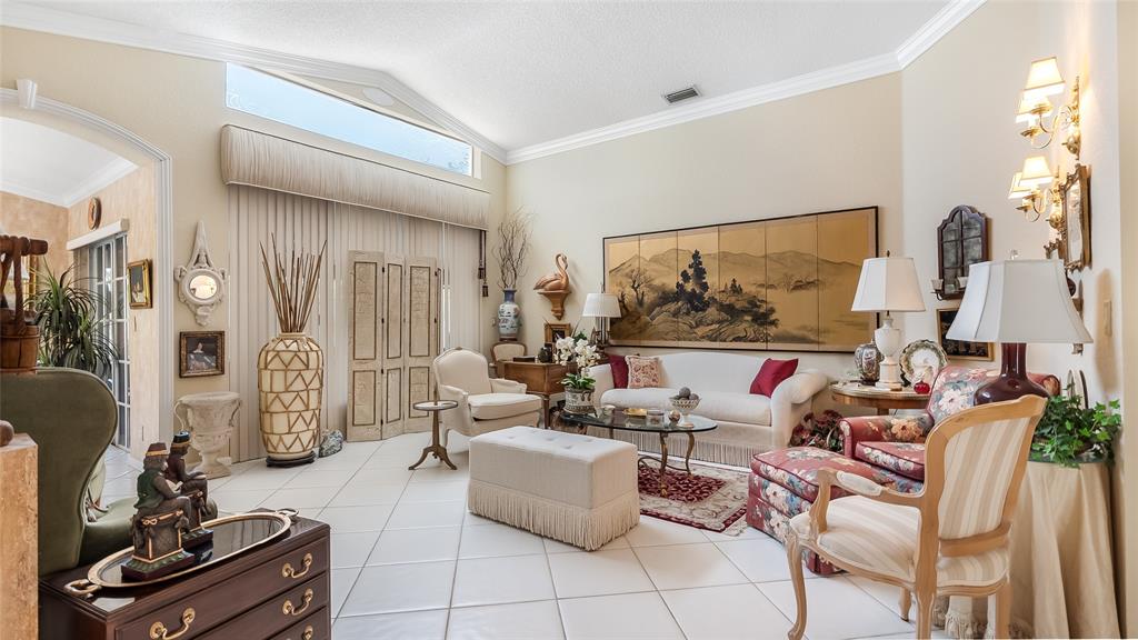 7844 Travelers Tree Drive Boca Raton, FL 33433 - Photo 4 of 40 a living room with furniture and a flat screen tv