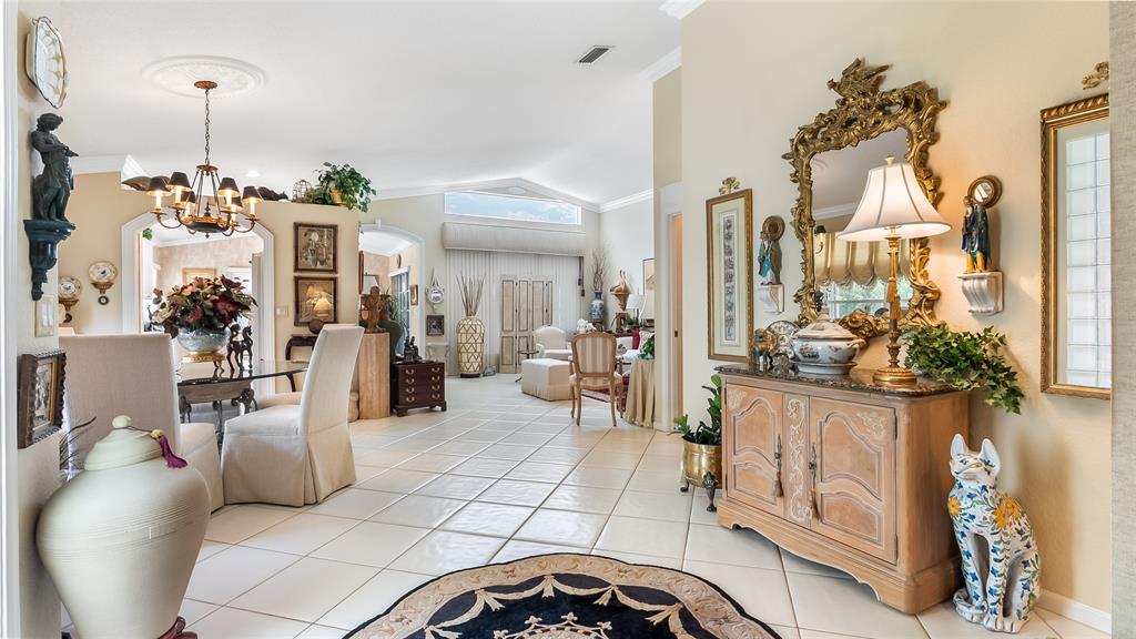 7844 Travelers Tree Drive Boca Raton, FL 33433 - Photo 5 of 40 a living room with furniture and a chandelier
