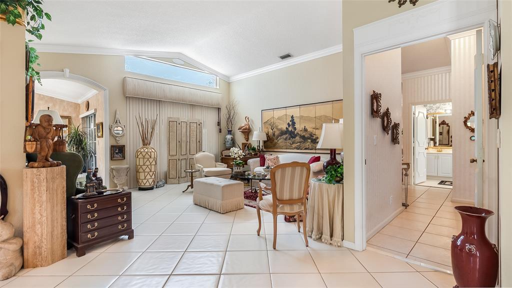 7844 Travelers Tree Drive Boca Raton, FL 33433 - Photo 7 of 40 a living room with furniture and a refrigerator