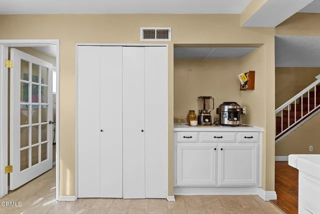 a view of kitchen with cabinets and window