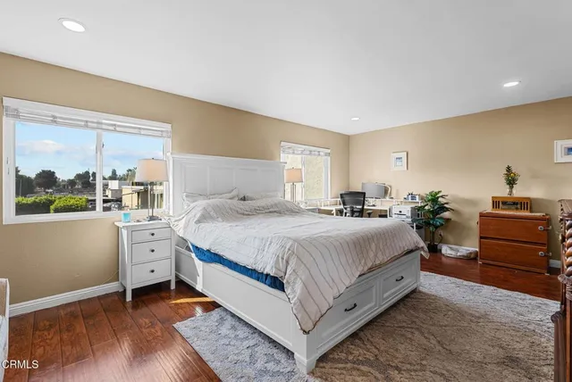 a spacious bedroom with a bed and a dresser