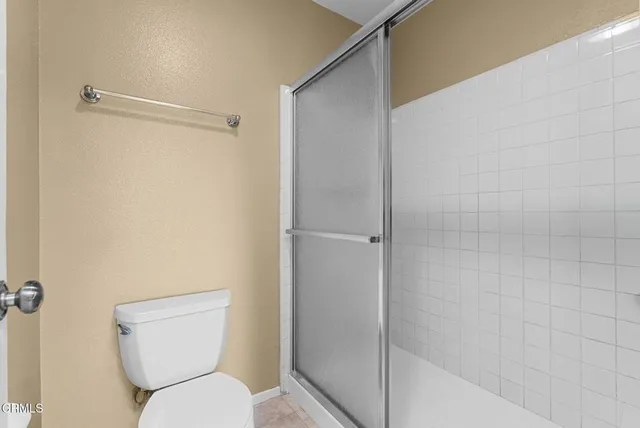 a bathroom with a toilet and shower