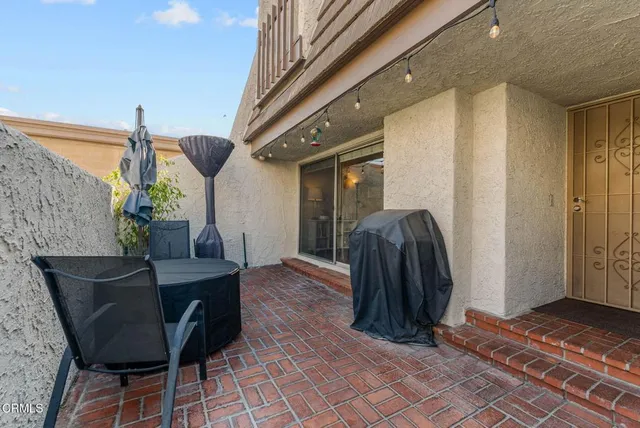 a view of balcony with furniture and a potted plant