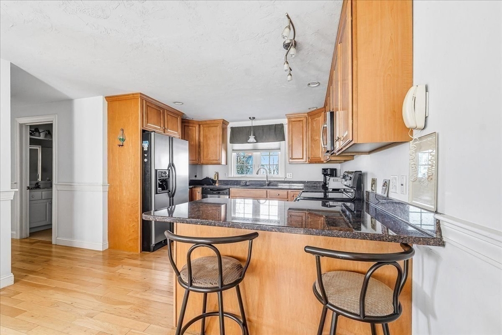4 Old Field Road, Unit 4 Plymouth, MA 02360 - Photo 14 of 42 a kitchen with stainless steel appliances granite countertop a refrigerator a sink a stove and island with wooden floor