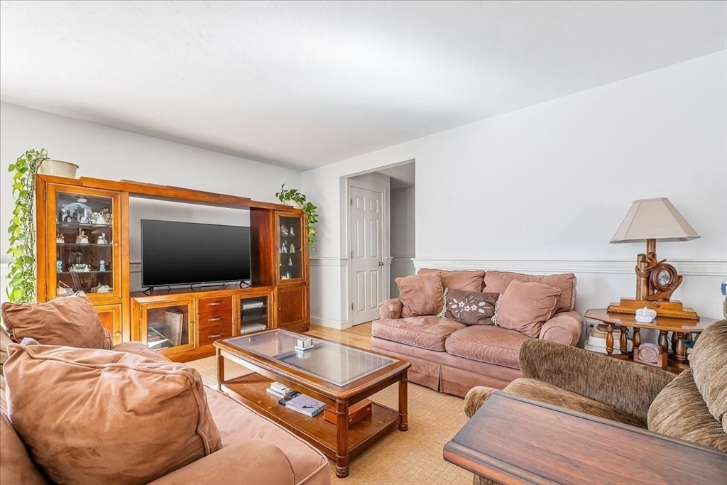 4 Old Field Road, Unit 4 Plymouth, MA 02360 - Photo 19 of 42 a living room with furniture and a flat screen tv
