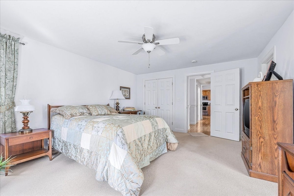 4 Old Field Road, Unit 4 Plymouth, MA 02360 - Photo 23 of 42 a spacious bedroom with a bed and a walk in closet