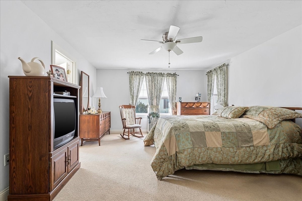 4 Old Field Road, Unit 4 Plymouth, MA 02360 - Photo 24 of 42 a bedroom with a bed flat screen tv and a couch