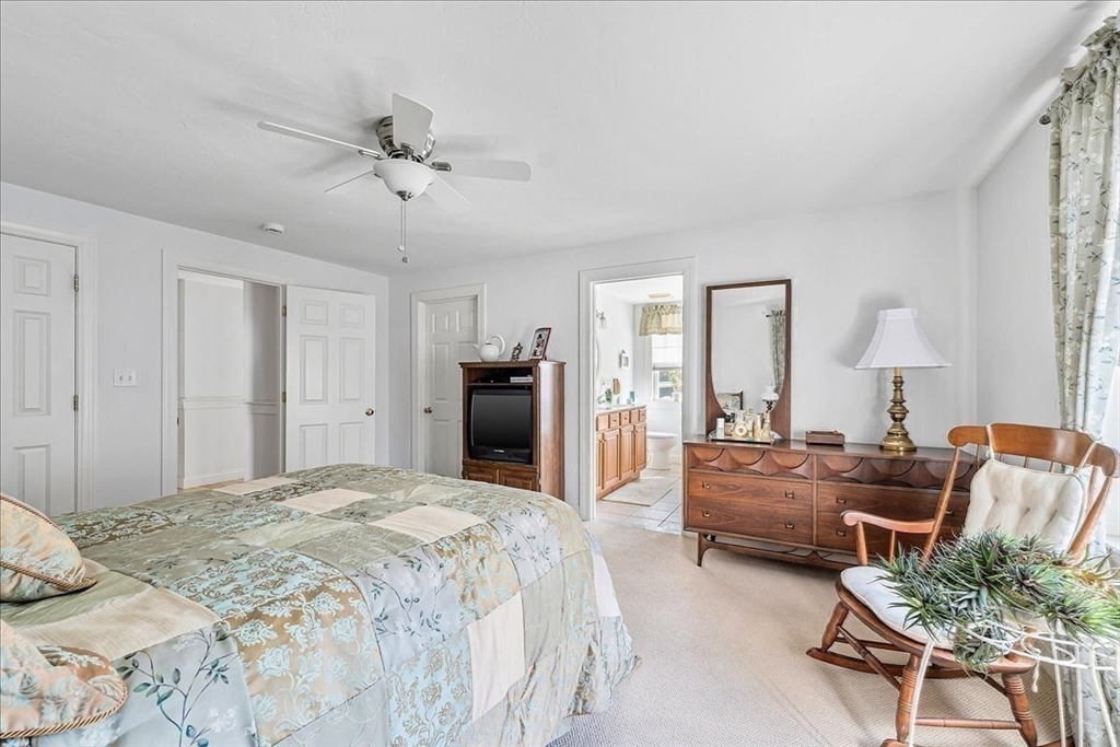 4 Old Field Road, Unit 4 Plymouth, MA 02360 - Photo 26 of 42 a bedroom with furniture and a chandelier