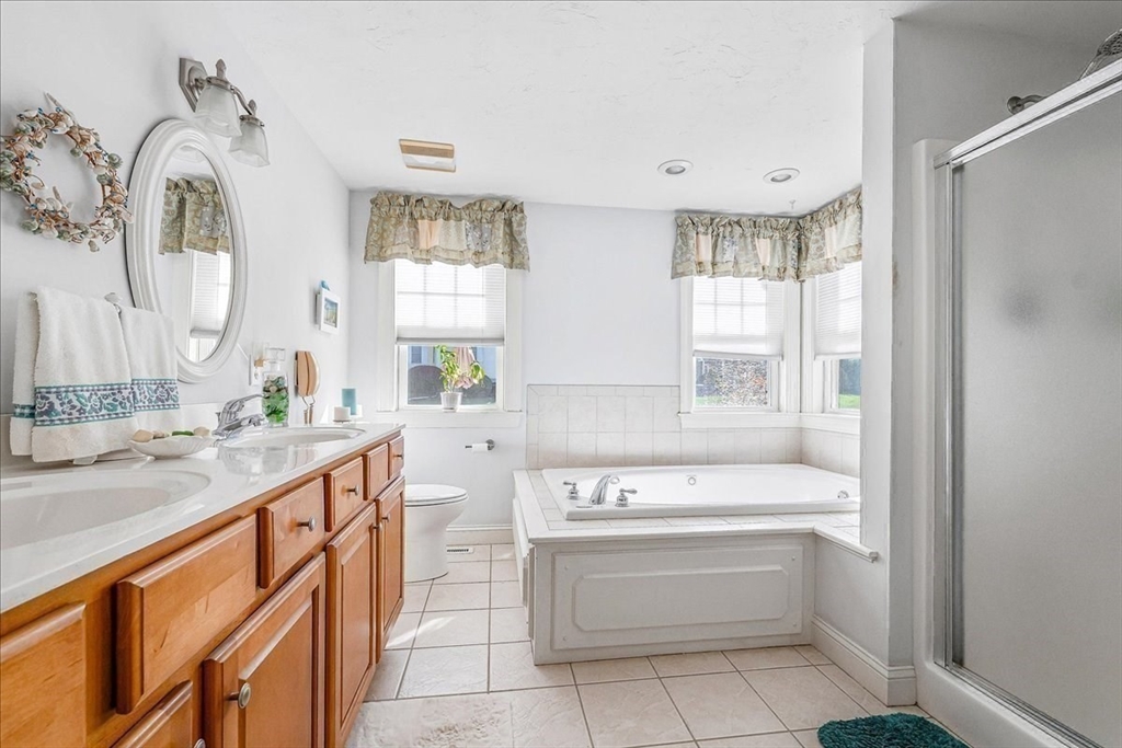 4 Old Field Road, Unit 4 Plymouth, MA 02360 - Photo 27 of 42 a bathroom with a tub sink and mirror