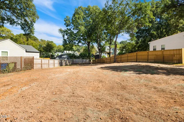a view of a backyard with large trees