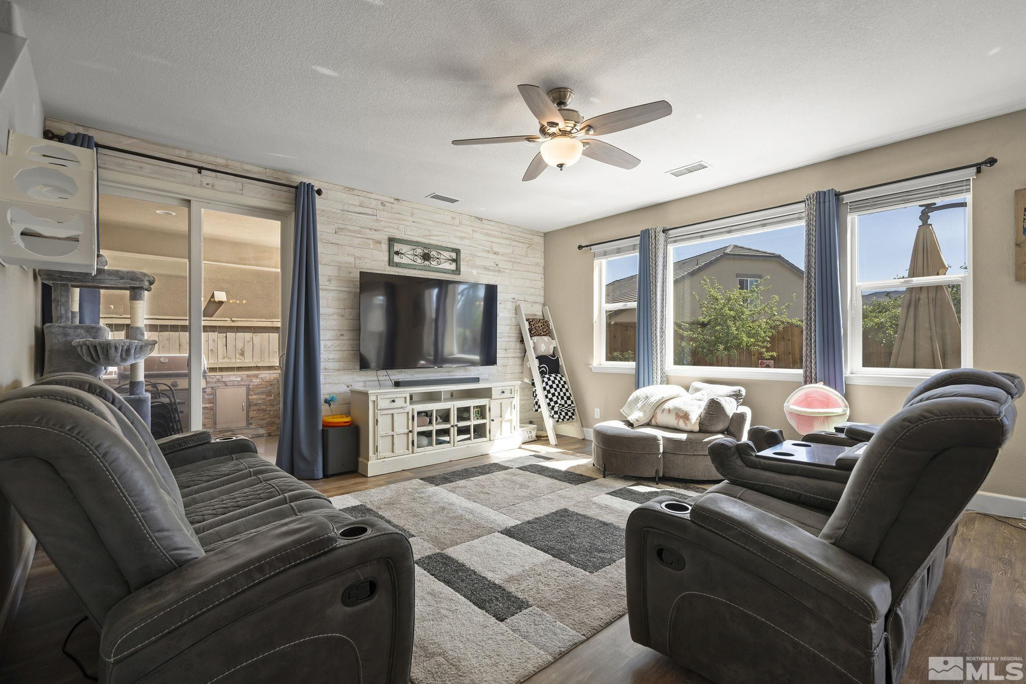 10320 Mott Drive Reno, NV 89521 - Photo 4 of 40 a living room with furniture a flat screen tv and a large window