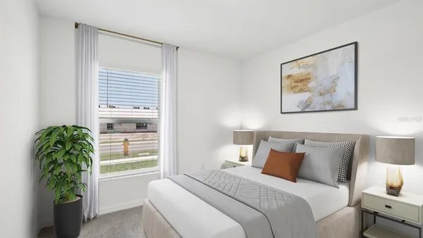 a bedroom with furniture and a potted plant