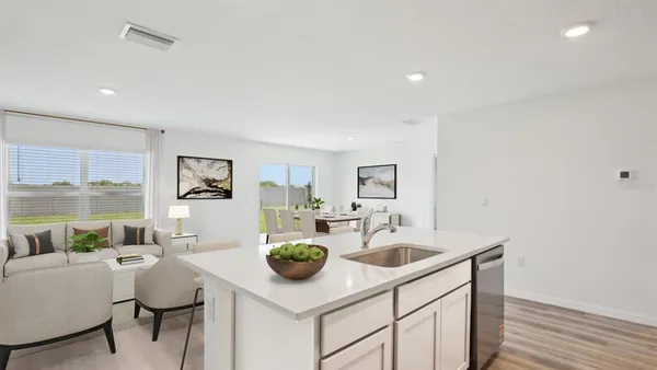 a kitchen with a sink cabinets and wooden floor
