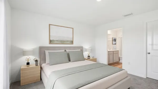 a bedroom with a bed and a painting