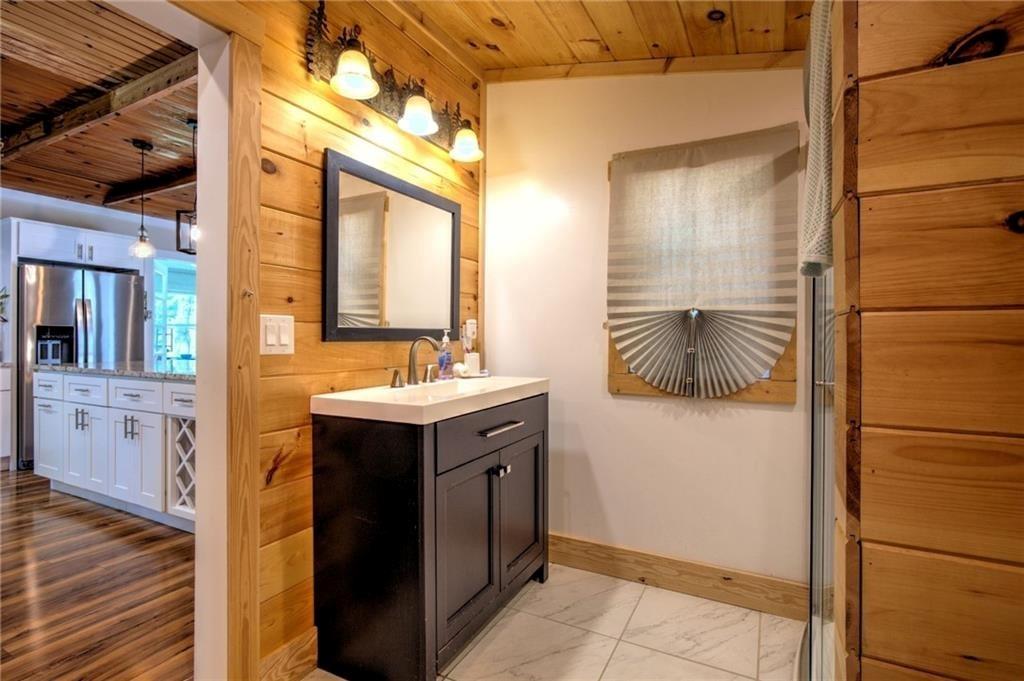 18131 Morganton Highway Morganton, GA 30560 - Photo 17 of 71 a bathroom with a sink a mirror and a shower