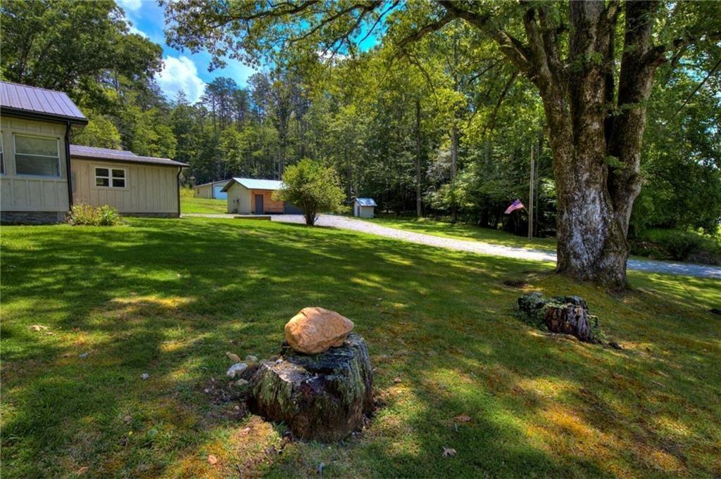18131 Morganton Highway Morganton, GA 30560 - Photo 36 of 71 a backyard of a house with table and chairs