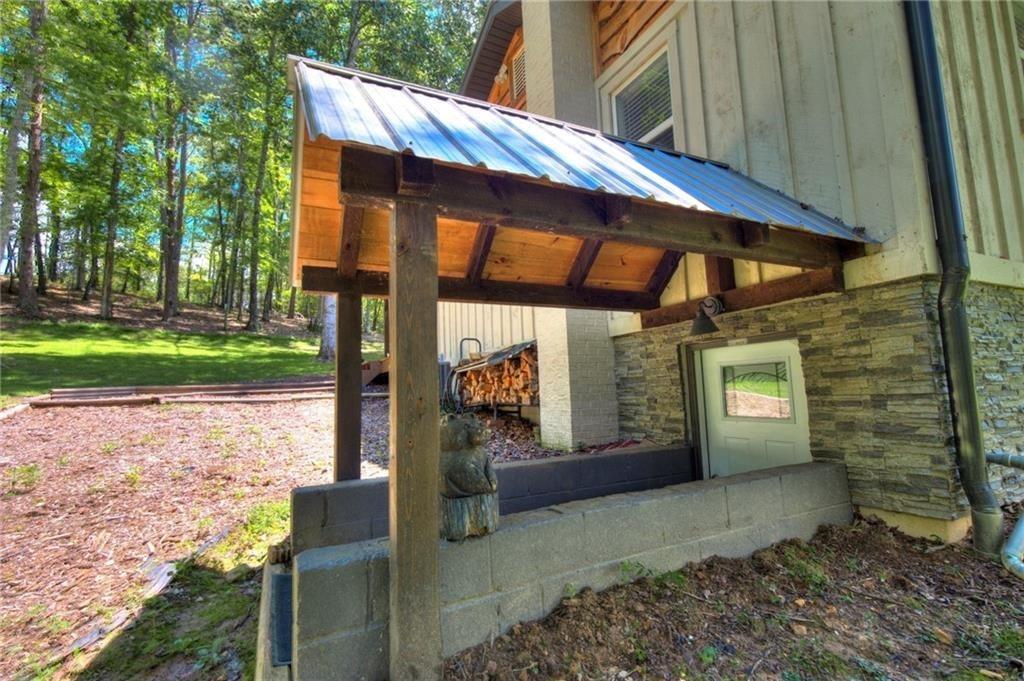 18131 Morganton Highway Morganton, GA 30560 - Photo 52 of 71 a backyard of a house with barbeque oven table and chairs