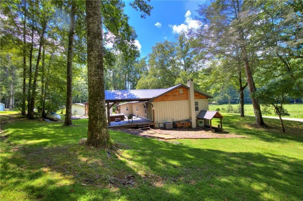 18131 Morganton Highway Morganton, GA 30560 - Photo 54 of 71 a view of a backyard with a sitting area and a tree