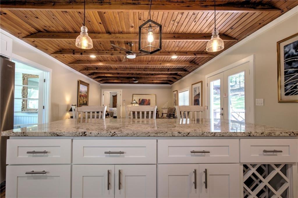 18131 Morganton Highway Morganton, GA 30560 - Photo 6 of 71 a open kitchen with granite countertop white cabinets and chandelier