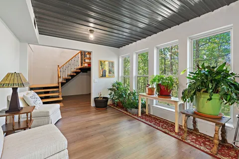 a view of entryway and hall with wooden floor