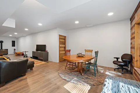 a living room with furniture a flat screen tv and a table