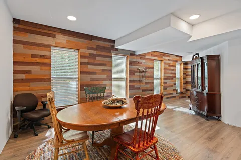 a view of a dining room with furniture and window