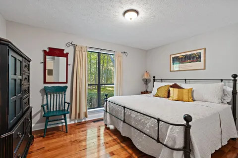 a bedroom with a bed and a large window