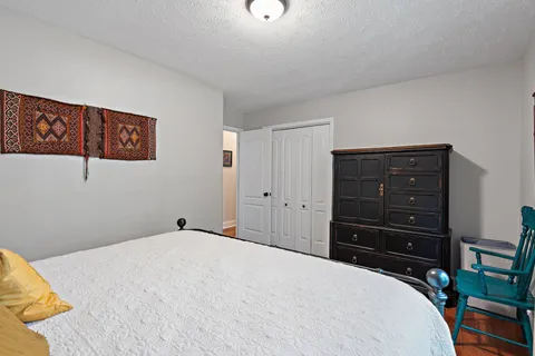 a bedroom with a bed and a dresser