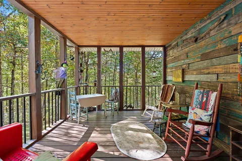 a view of a balcony with chairs and wooden floor