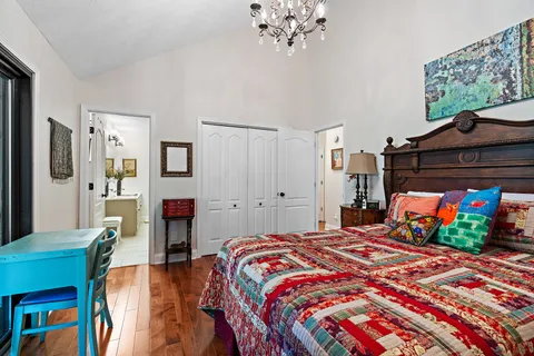 a bedroom with a bed window and a table