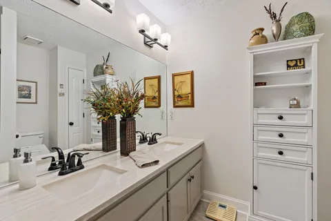 a bathroom with a sink a vanity and a mirror