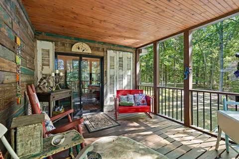 a living room filled with furniture and a floor to ceiling window