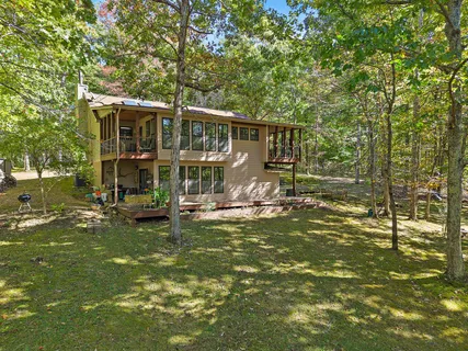 a view of a house with backyard porch and sitting area