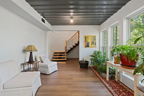a view of entryway and hall with wooden floor
