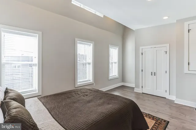 a spacious bedroom with a bed and a window