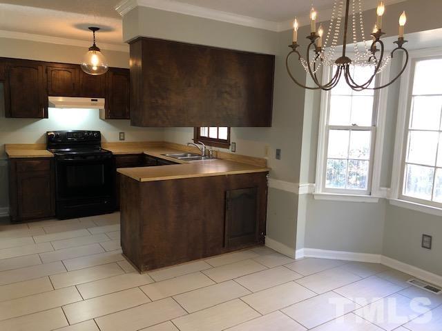 2804 Steeplechase Court Raleigh, NC 27613 - Photo 16 of 41 a kitchen with stainless steel appliances granite countertop a stove a sink a refrigerator and a microwave