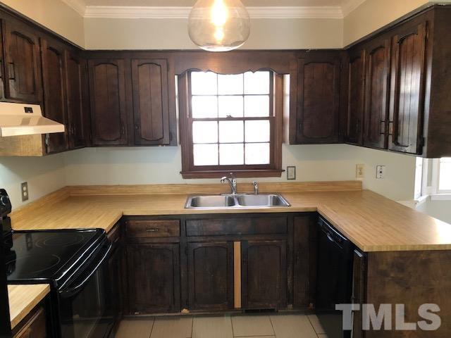 2804 Steeplechase Court Raleigh, NC 27613 - Photo 17 of 41 a kitchen with a sink and a stove