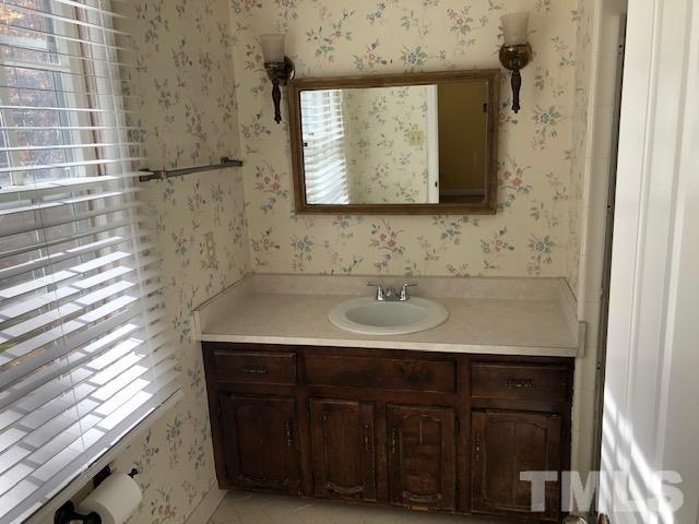 2804 Steeplechase Court Raleigh, NC 27613 - Photo 21 of 41 a bathroom with a double vanity sink and a mirror