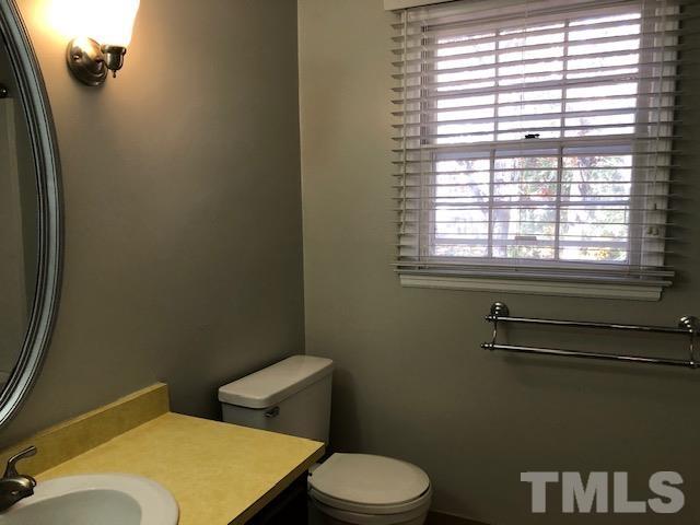 2804 Steeplechase Court Raleigh, NC 27613 - Photo 24 of 41 a bathroom with a toilet and a window