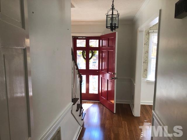 2804 Steeplechase Court Raleigh, NC 27613 - Photo 33 of 41 a hallway with wooden floor chandelier and entryway