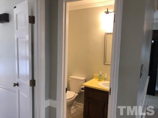 2804 Steeplechase Court Raleigh, NC 27613 - Photo 35 of 41 a bathroom with a granite countertop sink and mirror with toilet