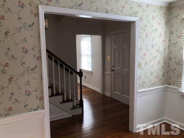 2804 Steeplechase Court Raleigh, NC 27613 - Photo 5 of 41 a view of a hallway with wooden floor and staircase