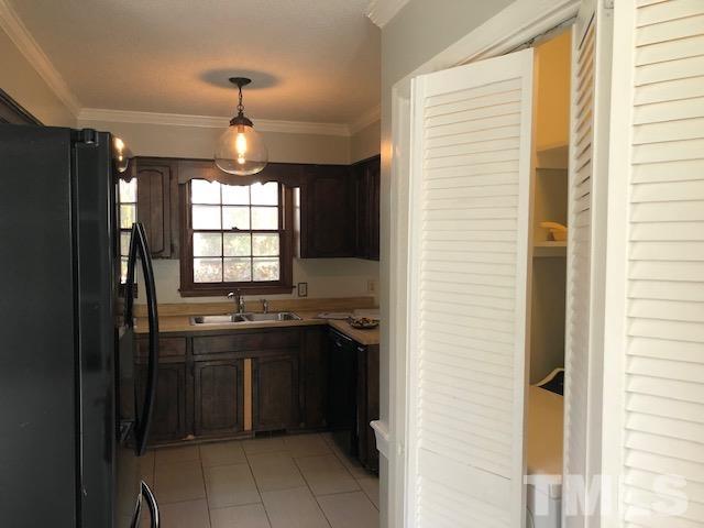 2804 Steeplechase Court Raleigh, NC 27613 - Photo 41 of 41 a kitchen with a sink a refrigerator and window
