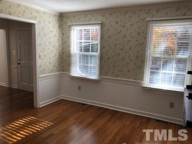 2804 Steeplechase Court Raleigh, NC 27613 - Photo 6 of 41 an empty room with wooden floor and windows