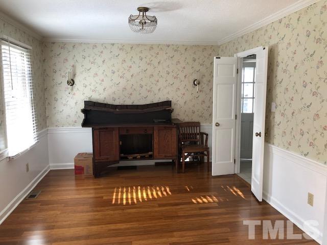 2804 Steeplechase Court Raleigh, NC 27613 - Photo 7 of 41 a living room with a fireplace and a wooden floor
